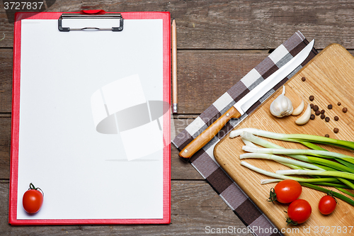 Image of Open blank recipe book on brown wooden background