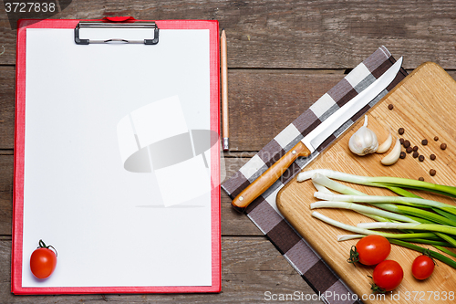 Image of Open blank recipe book on brown wooden background