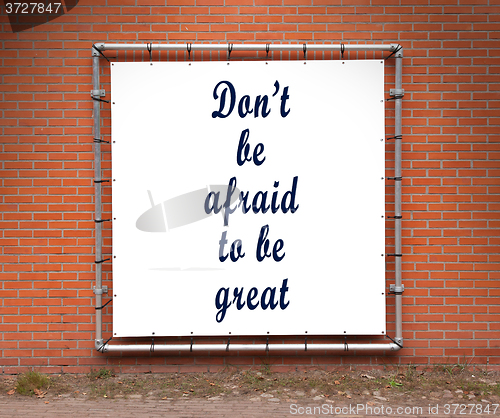 Image of Large banner with inspirational quote on a brick wall