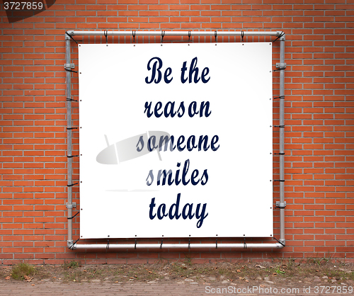 Image of Large banner with inspirational quote on a brick wall