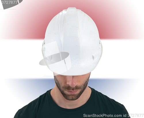 Image of Engineer with flag on background - Netherlands