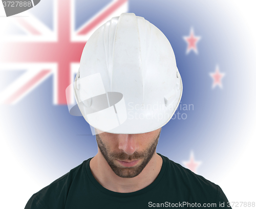 Image of Engineer with flag on background - New Zealand