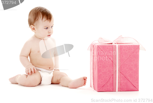 Image of baby boy in diaper with big gift box