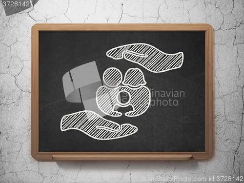 Image of Insurance concept: Family And Palm on chalkboard background