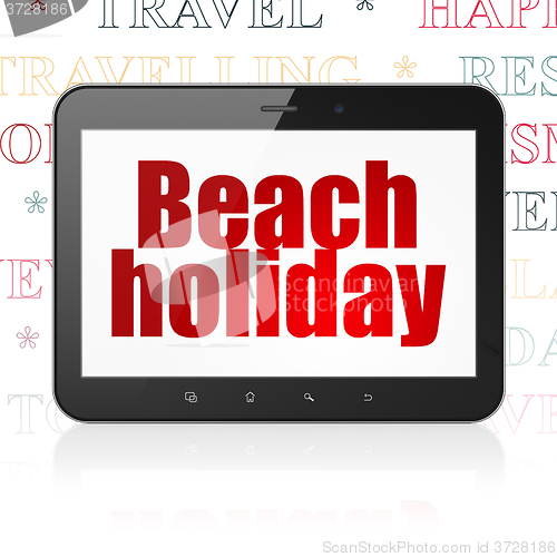 Image of Tourism concept: Tablet Computer with Beach Holiday on display