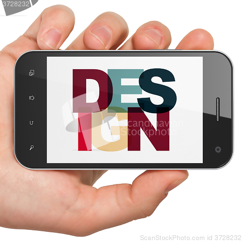 Image of Marketing concept: Hand Holding Smartphone with Design on  display