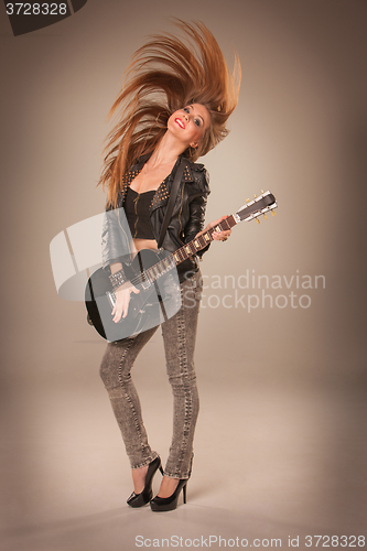 Image of Beautiful girl playing guitar