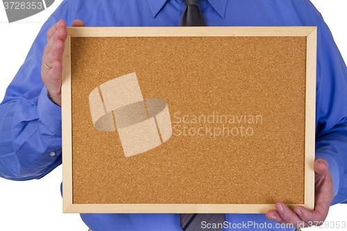 Image of Businessman holding empty pinboard