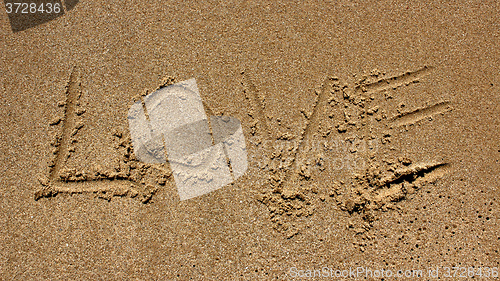 Image of love message written in sand