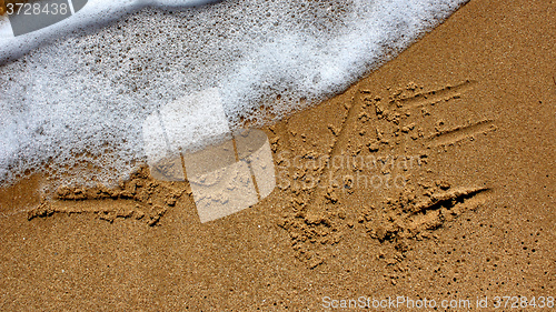 Image of love message written in sand