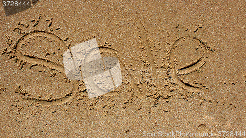 Image of Word sale handwritten in sand