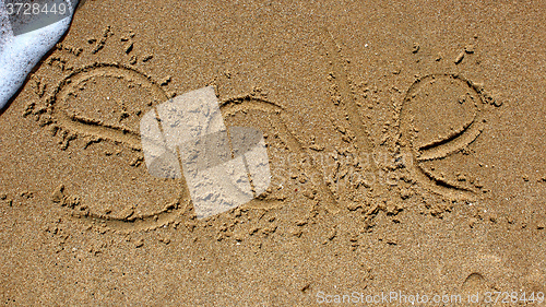 Image of Word sale handwritten in sand