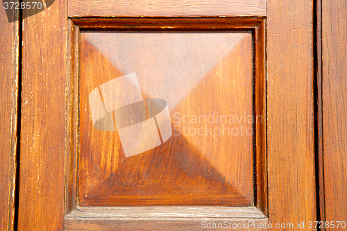 Image of abstract texture of a  old door in italy  