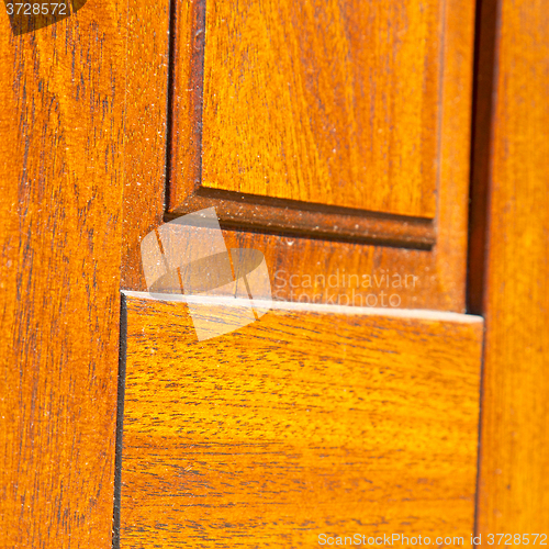 Image of abstract texture of a brown antique wooden old door in italy   e