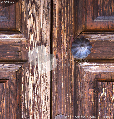 Image of brass  knocker and wood  glass door caronno varesino varese  