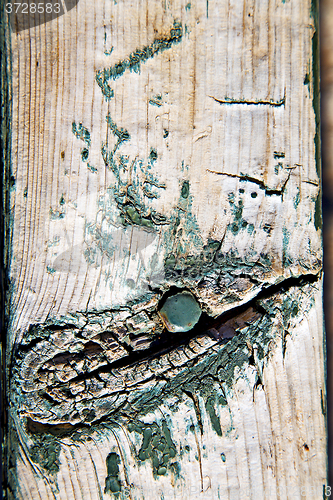 Image of green paint in the brown wood door and rusty  yellow  