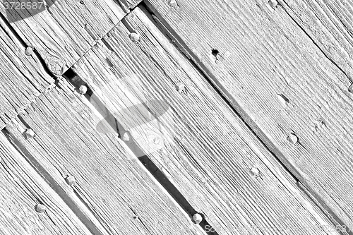 Image of abstract texture of a brown antique wooden old door in italy   e