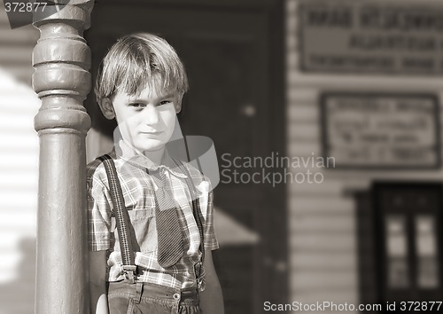 Image of boy in front of shop