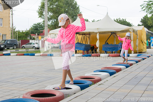 Image of Two girls walking with interest on tires protecting circuit