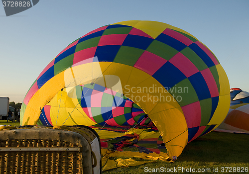 Image of The envelope of a hot air balloon being inflated on the ground