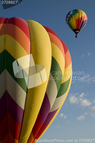 Image of Hot air balloons launching against a blue sky