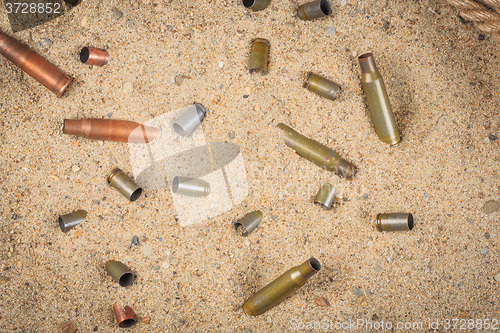 Image of cartridge cases on the sand.