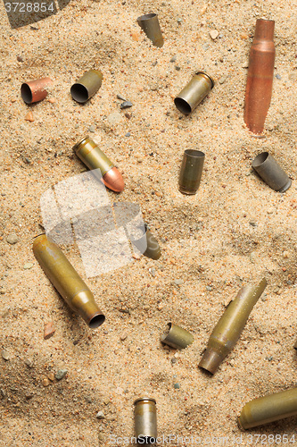 Image of cartridge cases on the sand.