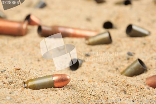 Image of cartridge cases on the sand.