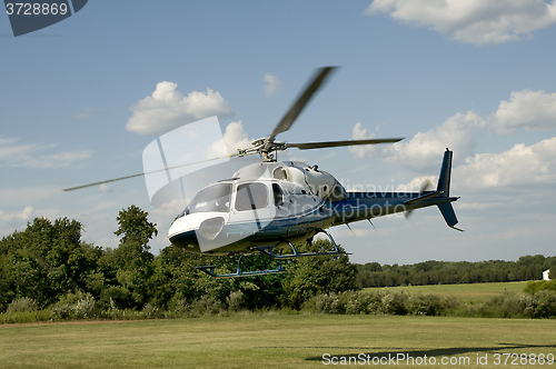 Image of Helicopter taking off or landing in a field