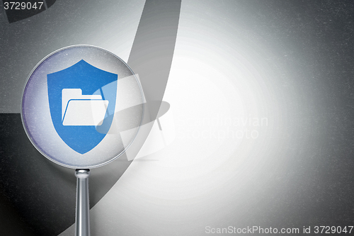 Image of Finance concept:  Folder With Shield with optical glass on digital background