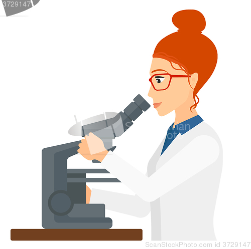 Image of Laboratory assistant with microscope.