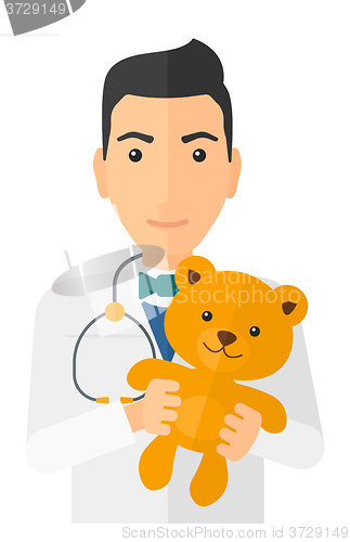 Image of Pediatrician holding teddy bear.