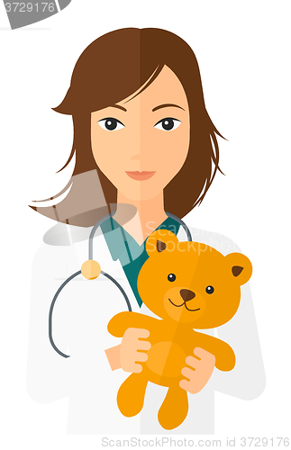 Image of Pediatrician holding teddy bear.