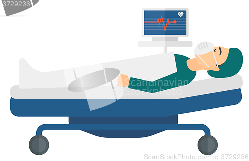 Image of Patient lying in bed with heart monitor.