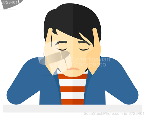 Image of Anxious man clutching his head.