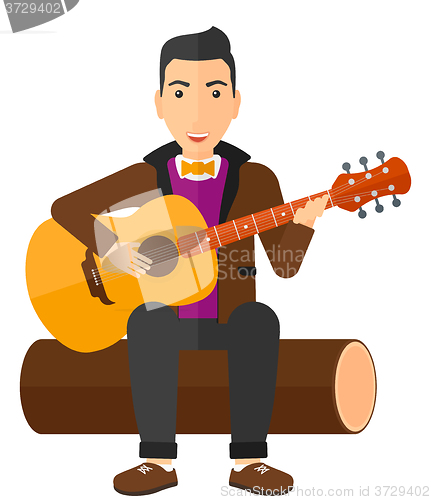 Image of Man playing guitar.