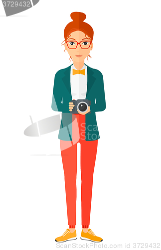 Image of Smiling photographer holding camera.