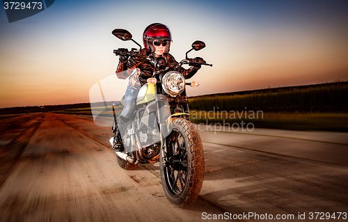 Image of Biker girl on a motorcycle