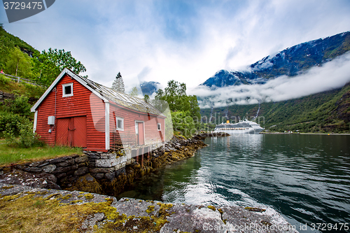 Image of Norway landscape, the house on the shore of the fjord in the bac