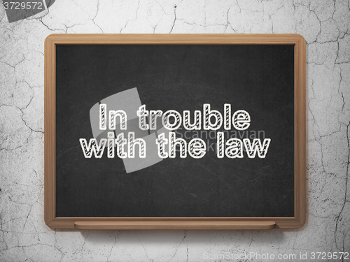 Image of Law concept: In trouble With The law on chalkboard background