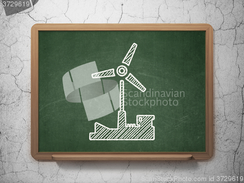 Image of Industry concept: Windmill on chalkboard background