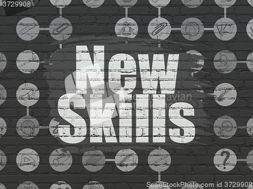 Image of Education concept: New Skills on wall background