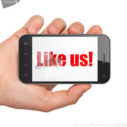 Image of Social network concept: Hand Holding Smartphone with Like us! on display