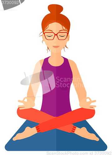 Image of Woman meditating in lotus pose.
