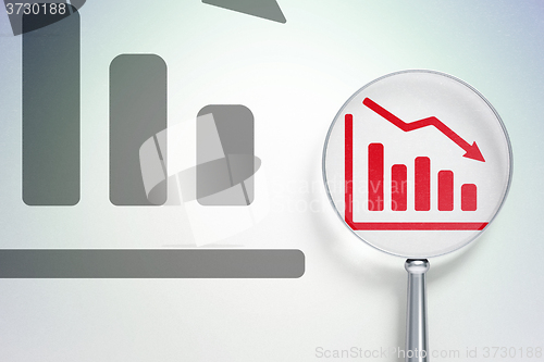 Image of Marketing concept:  Decline Graph with optical glass on digital background