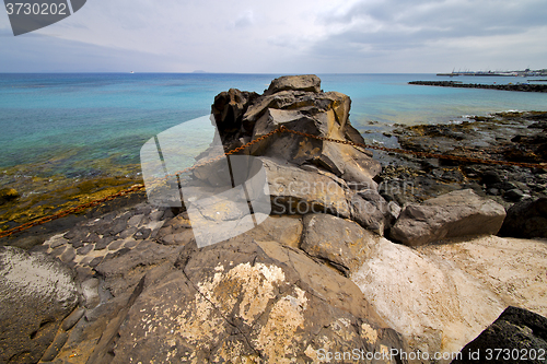 Image of pier rusty chain  water  boat   and summer lanzarote spain