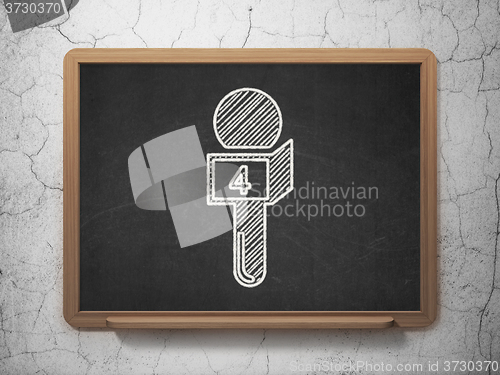 Image of News concept: Microphone on chalkboard background