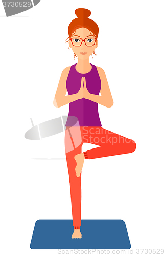 Image of Woman practicing yoga.