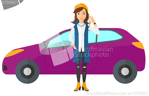 Image of Woman holding key from new car.