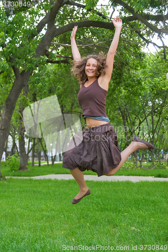 Image of Pretty girl jumping in park